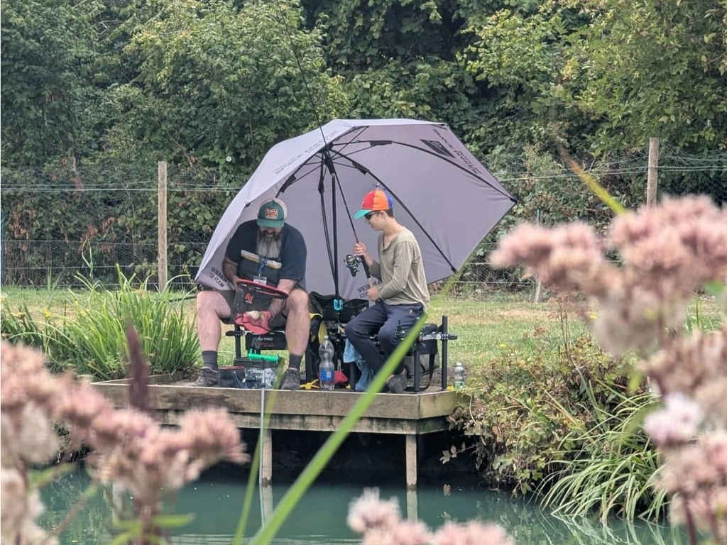 Coach helping student net fish.