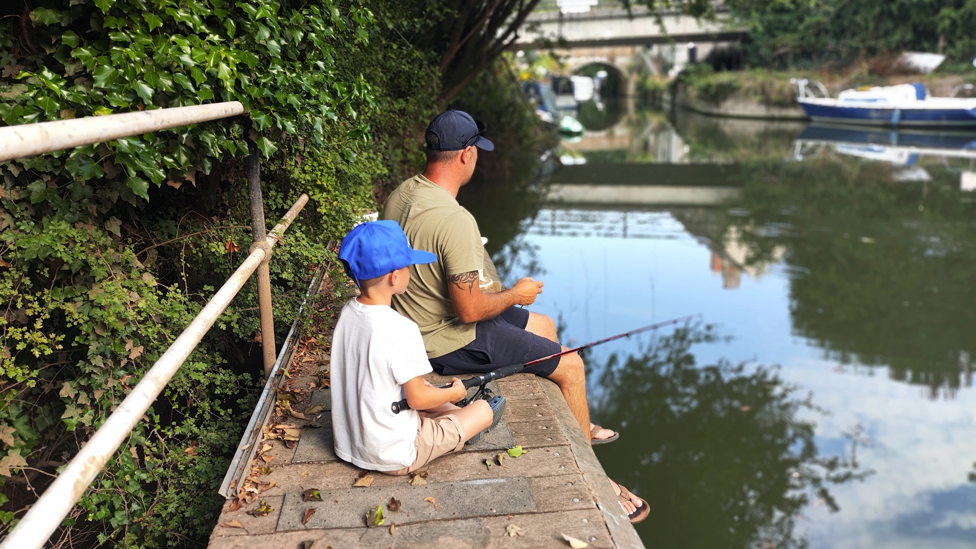 Image of father and son fishing on a canal