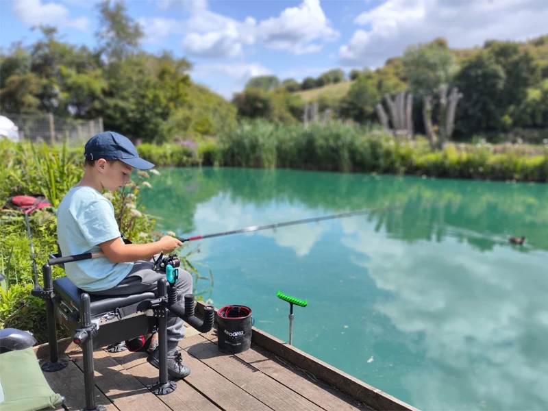 Young person relaxed and concetrating on fishing.